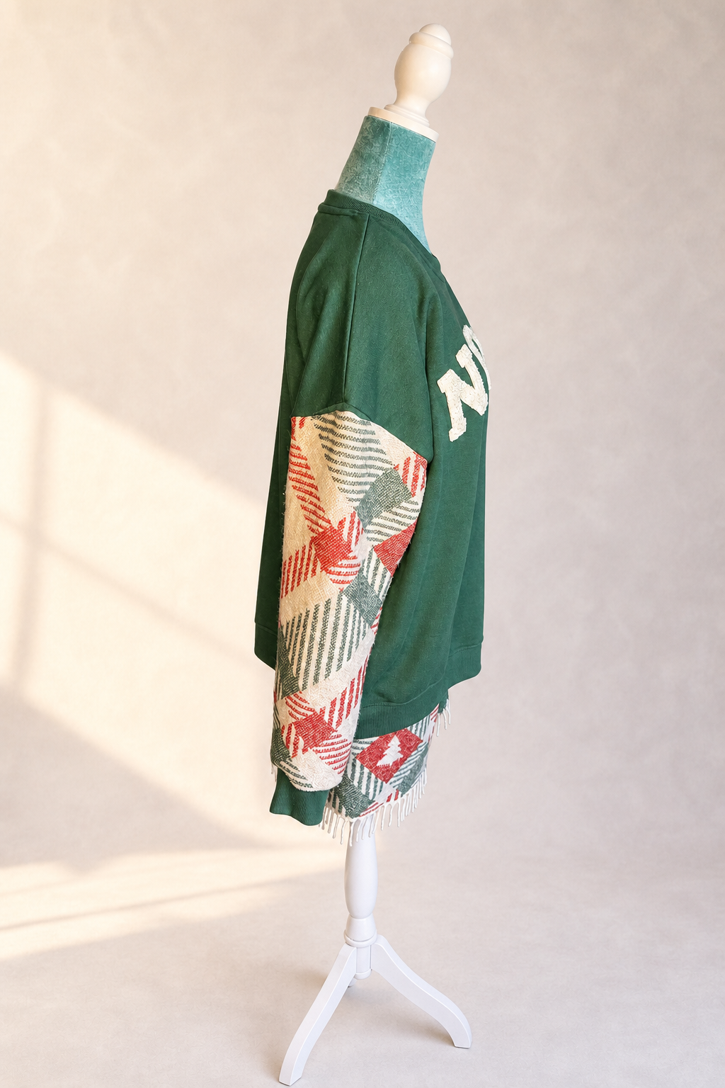 Right side view of The Noel Rework showing the woven textile sleeve, side seam, and original fringe